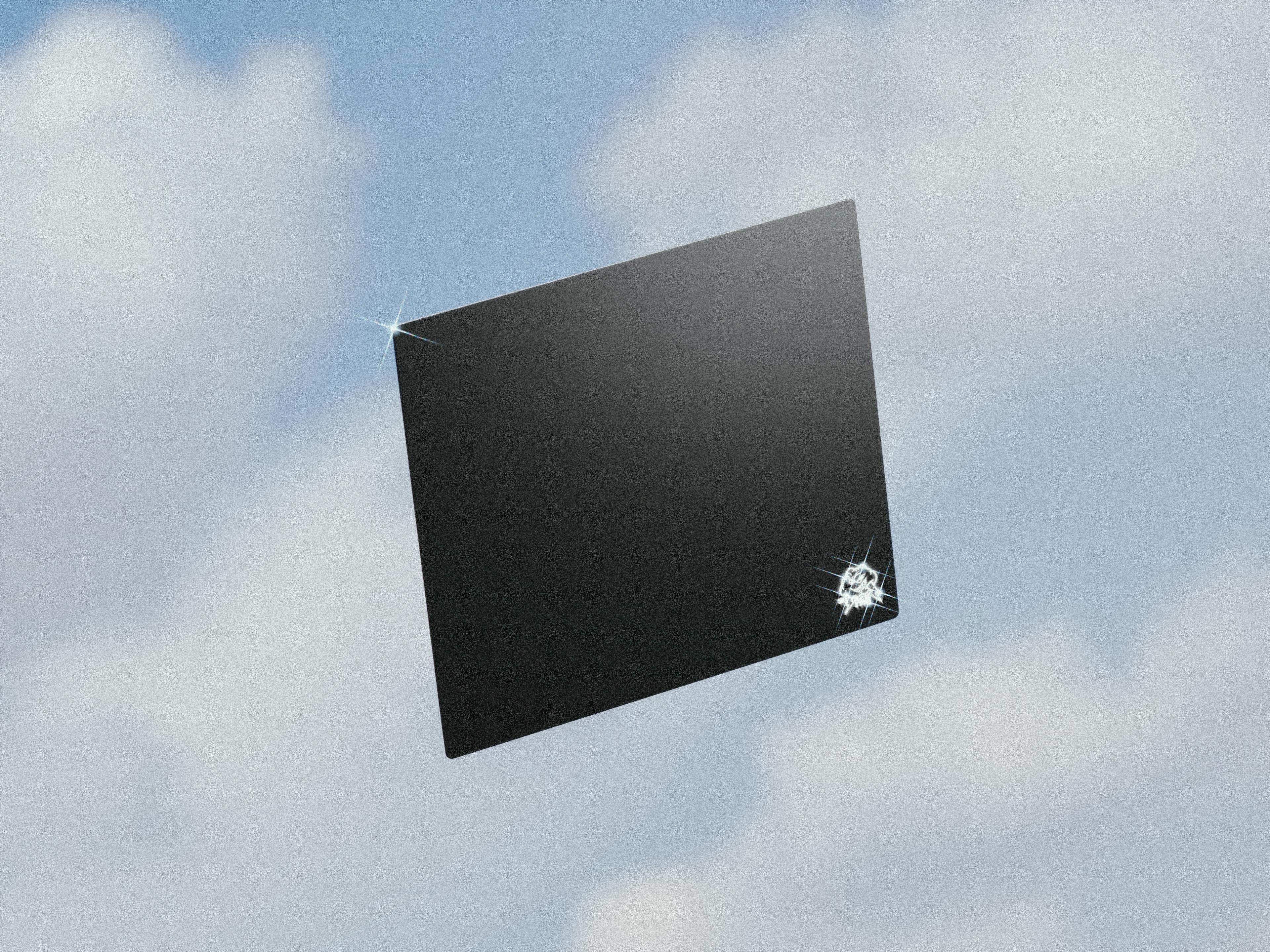 A black color SkyPad glass vintage mouse pad floating in the air