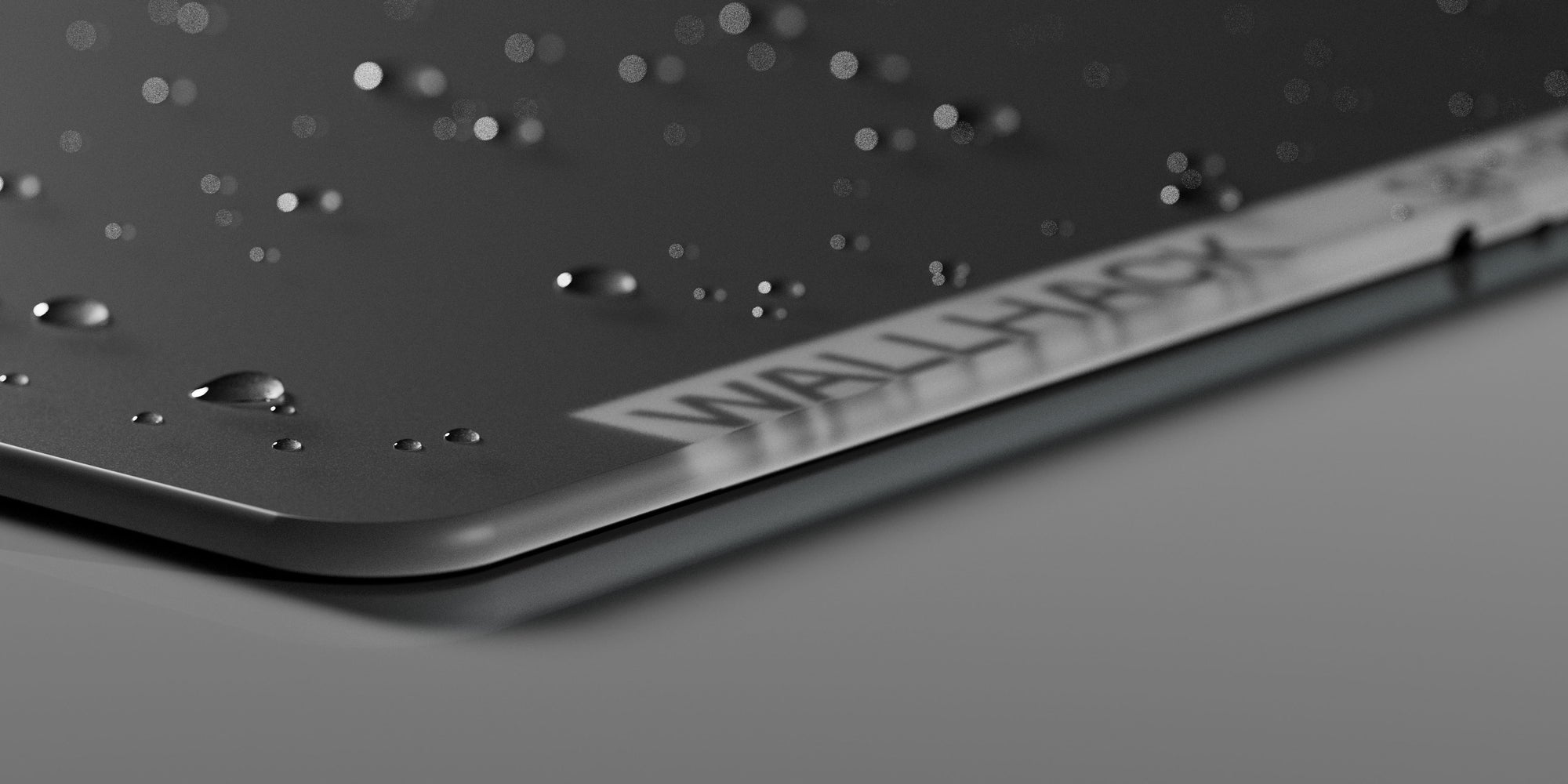 A close up of the Wallhack glass mouse pad with water droplets to showcase water resistance