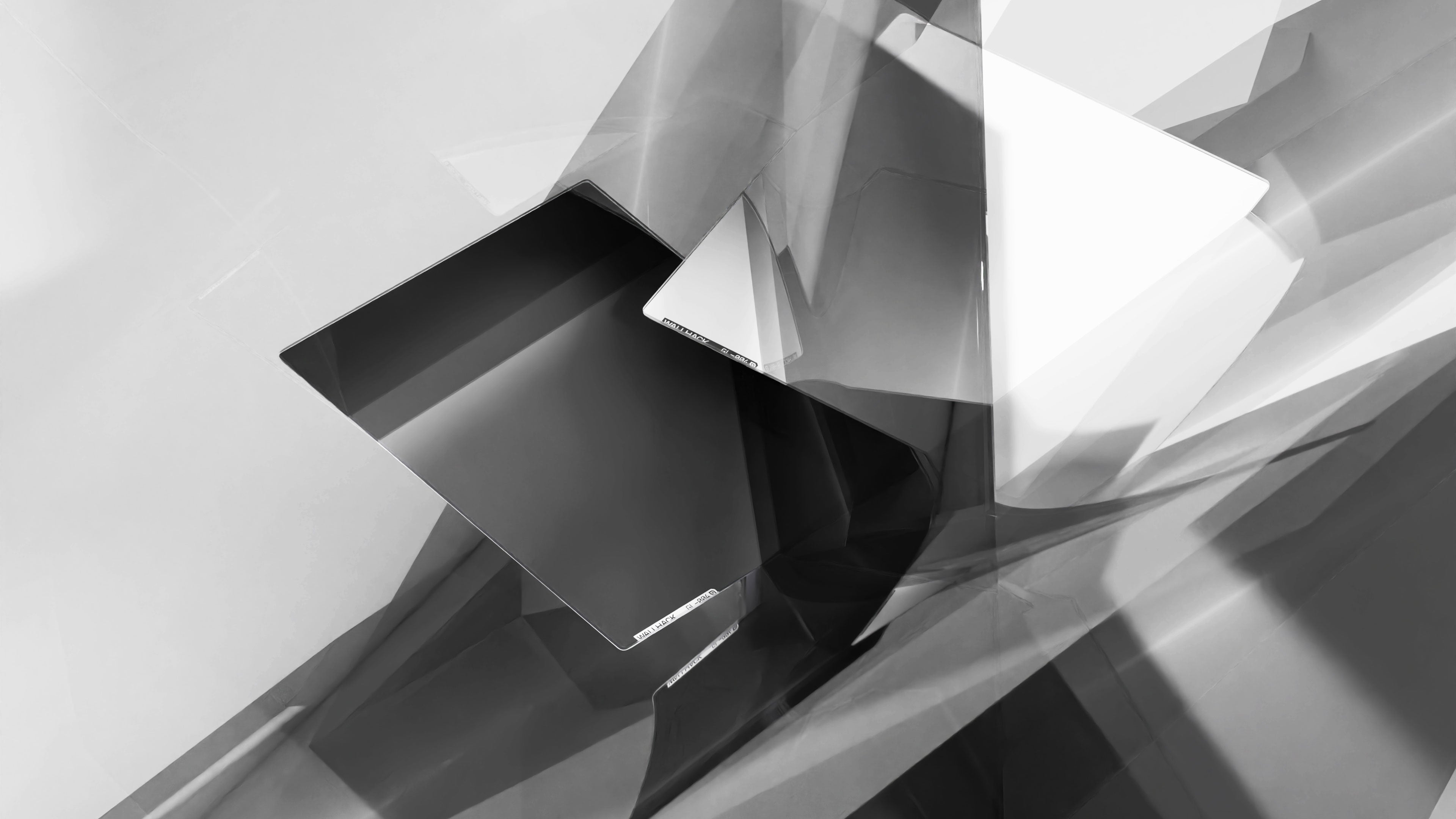 A black glass mouse pad within white glass shards